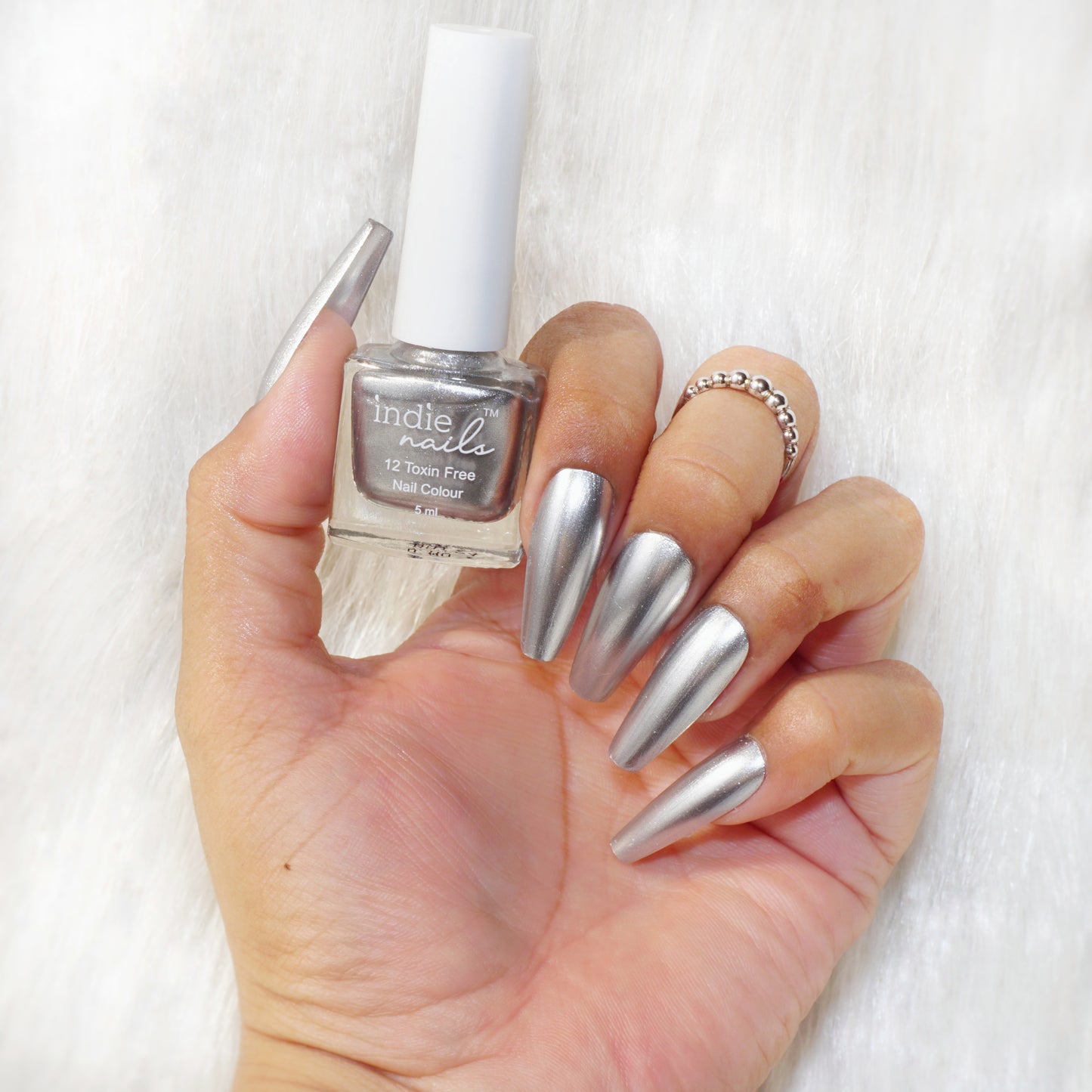 Silver Sonic nail polish swatch on medium Indian skin tone, Indie Nails Silver Sonic bottle with minimalist background, Close-up of nails painted with Silver Sonic shade
