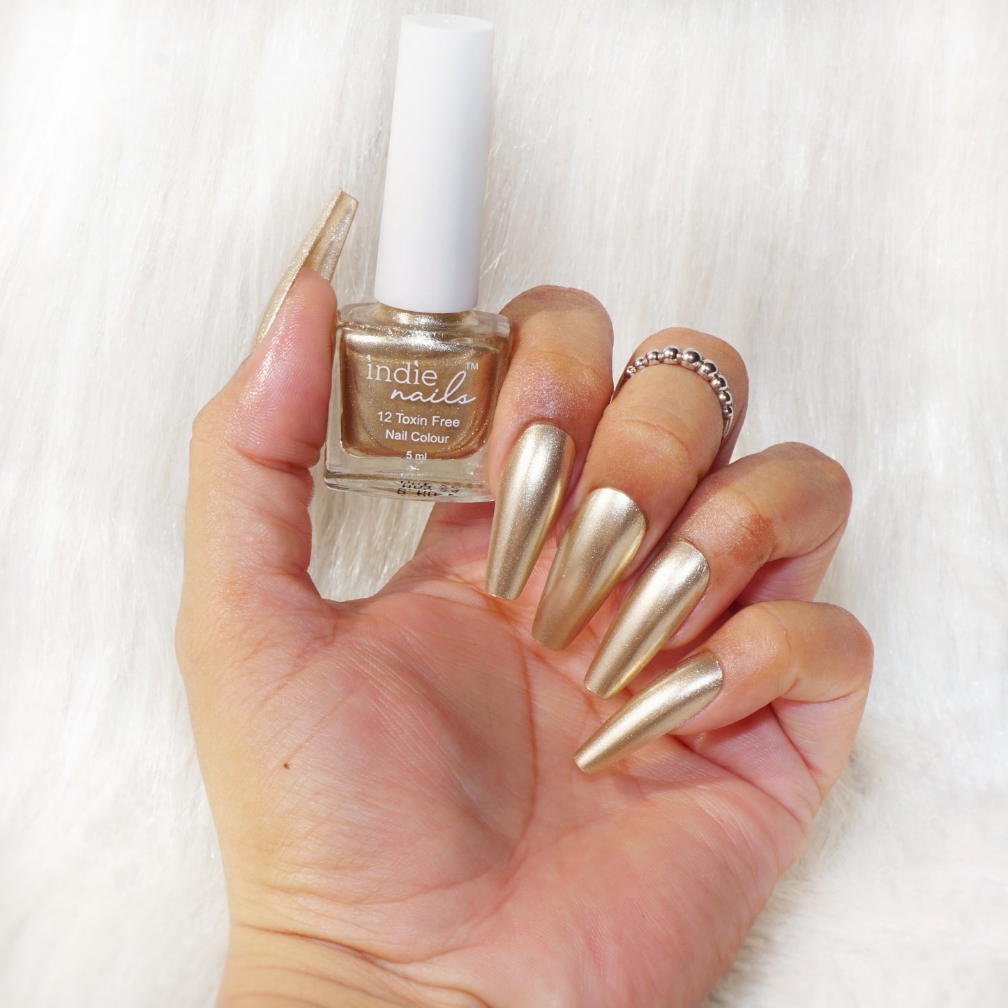 Golden tan metallic nail polish bottle – Solar Light by Indie Nails, Hand swatch of Solar Light nail polish with tan shimmer finish, Warm gold nail polish with metallic shine – Indie Nails Solar Light, Vegan golden tan nail paint for Indian skin – Solar Light shade, Cruelty-free metallic tan nail polish on medium skin tone