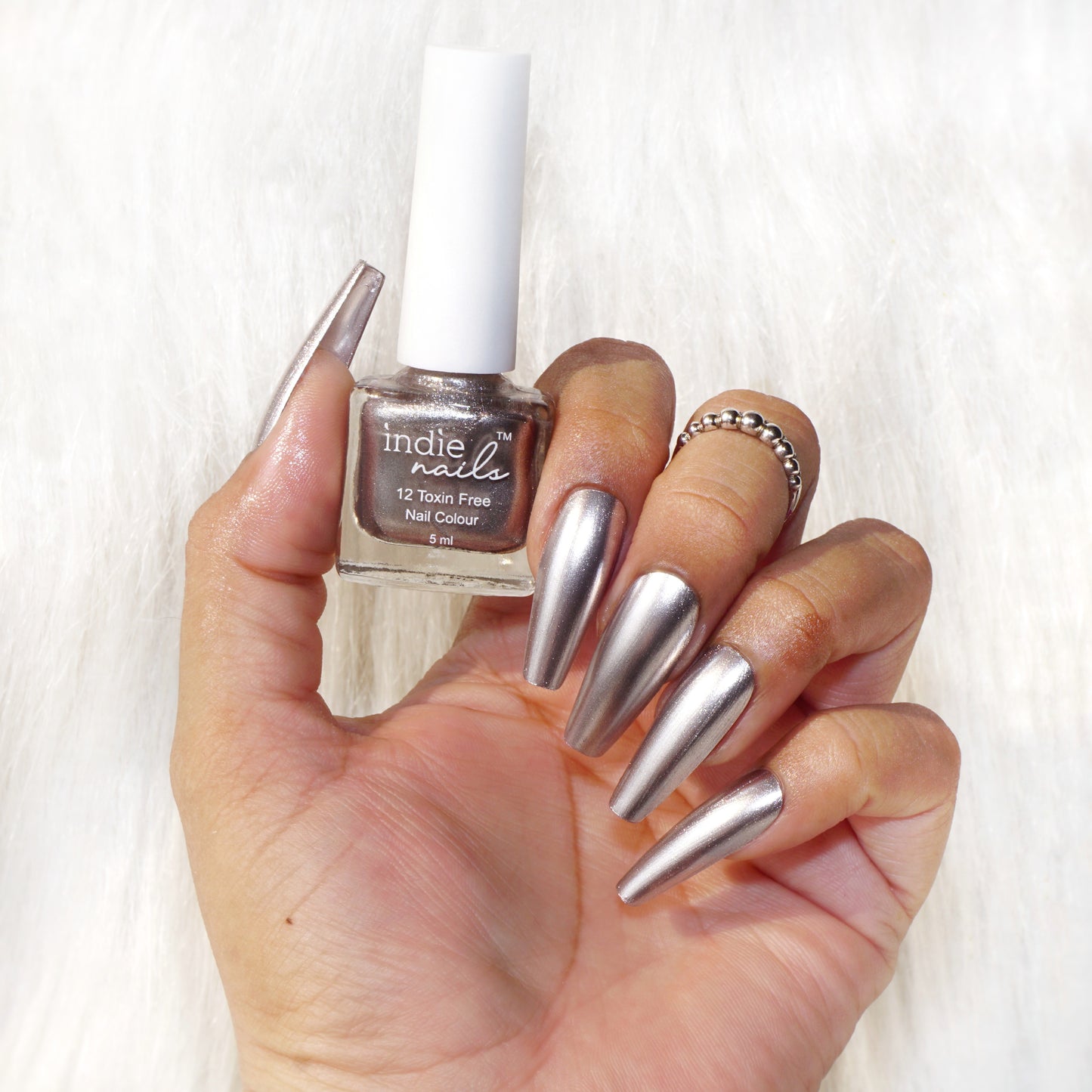 Outer Space nail polish swatch on medium Indian skin tone, Indie Nails Outer Space bottle with minimalist background,Close-up of nails painted with Outer Space shade