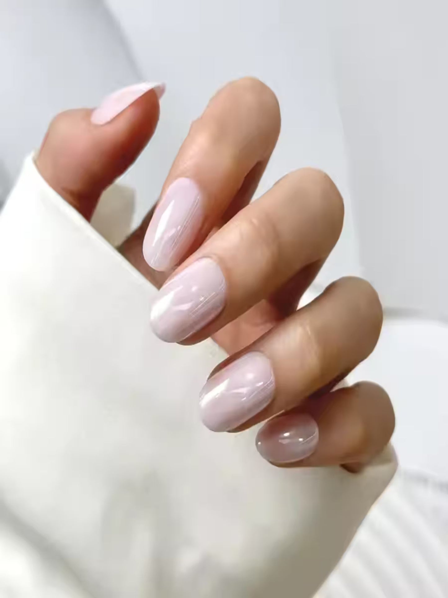 Beach Walk soft gel press-on nails kit with glue and tools, Nude glossy press-on nails in natural lighting