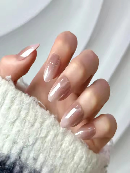 Mocha Twist soft gel press-on nails kit with glue and tools, Coffee brown press-on nails with glossy finish, Model hand wearing Mocha Twist soft gel nails