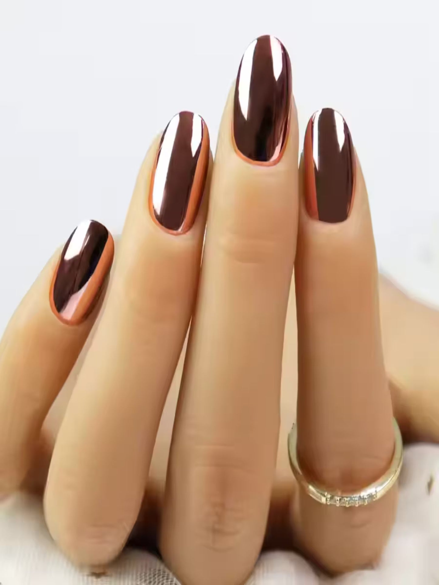 Close-up of glossy metallic nude press-on nails on model, Rose gold press-on nails applied on natural nails