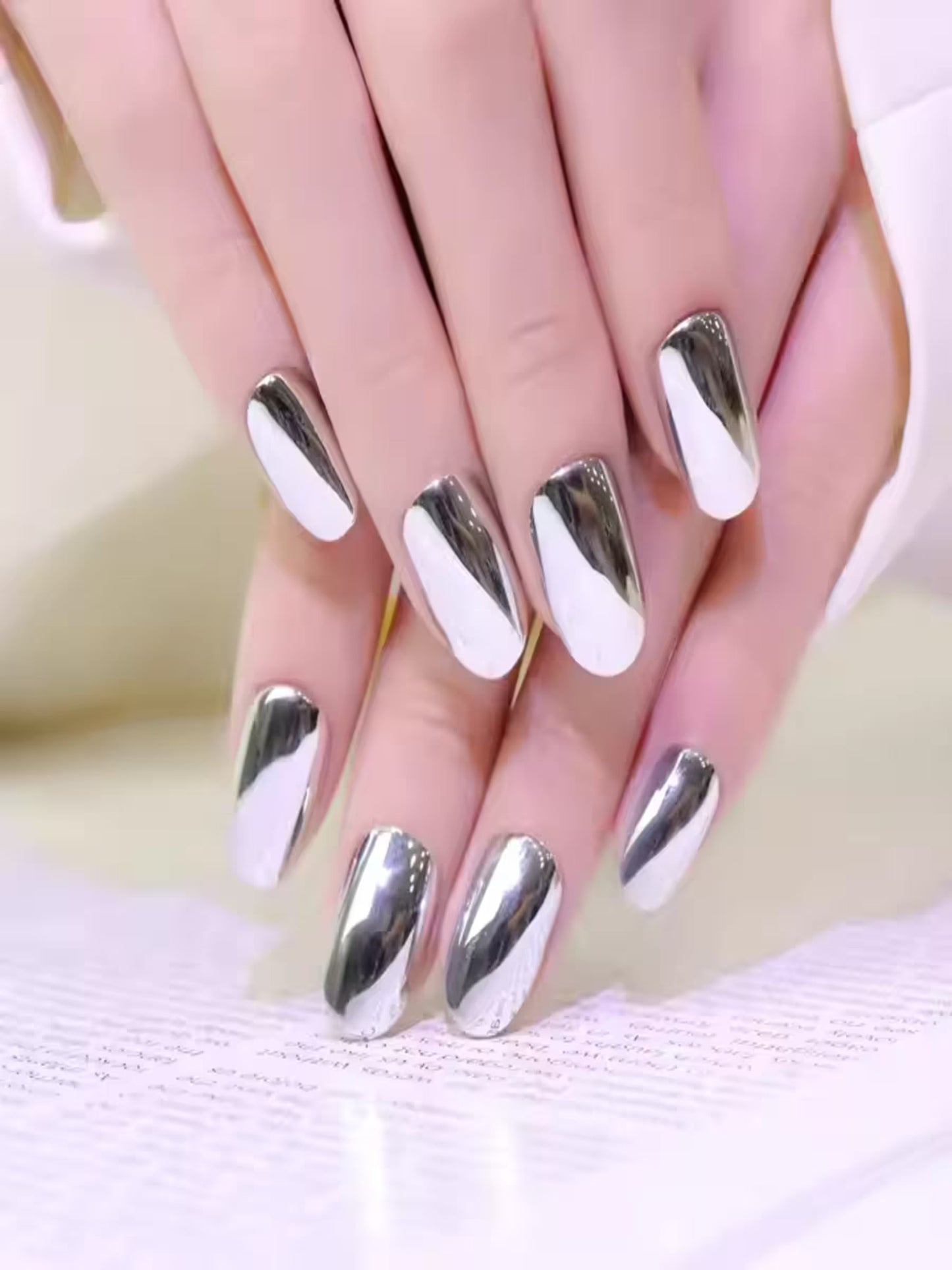Reflective metallic press-on nails laid out in flatlay